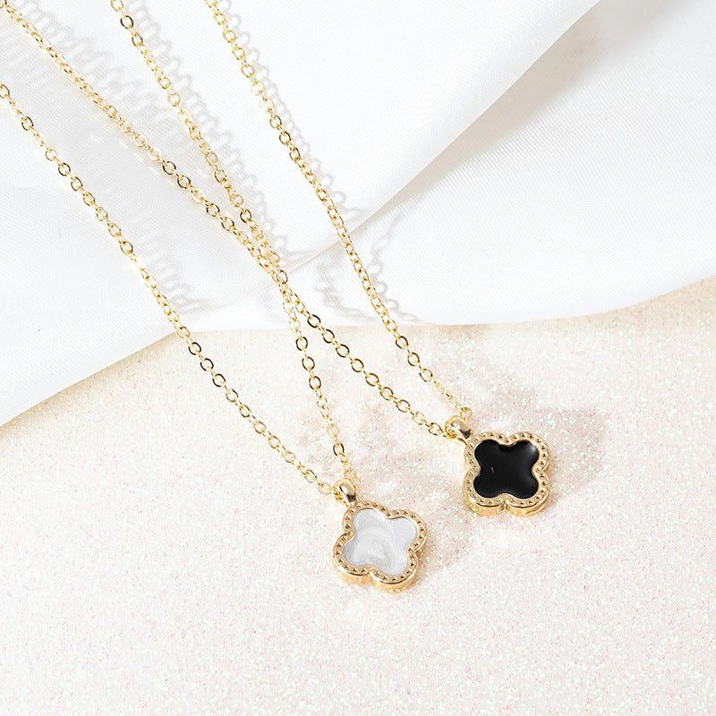 TWO IN ONE CLOVER NECKLACE WITH ONE SIDE BLACK AND ONE WHITE