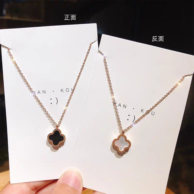 TWO IN ONE CLOVER NECKLACE WITH ONE SIDE BLACK AND ONE WHITE