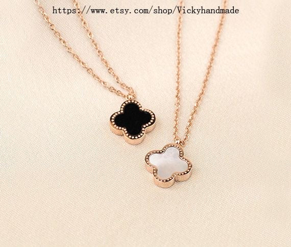 TWO IN ONE CLOVER NECKLACE WITH ONE SIDE BLACK AND ONE WHITE