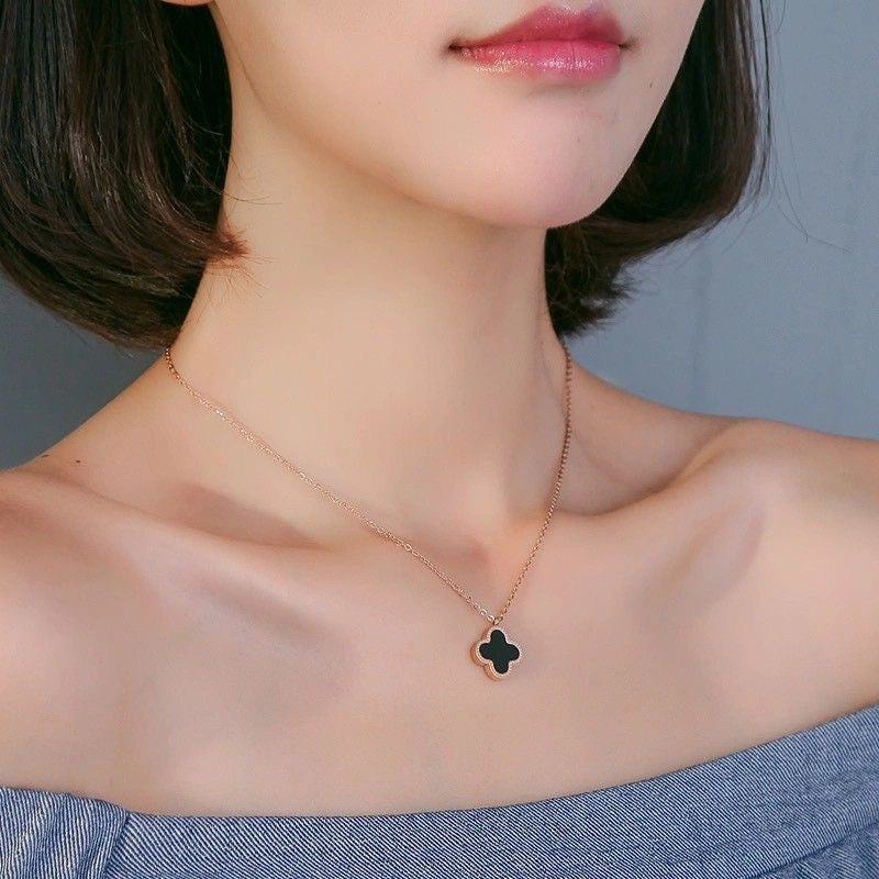 TWO IN ONE CLOVER NECKLACE WITH ONE SIDE BLACK AND ONE WHITE
