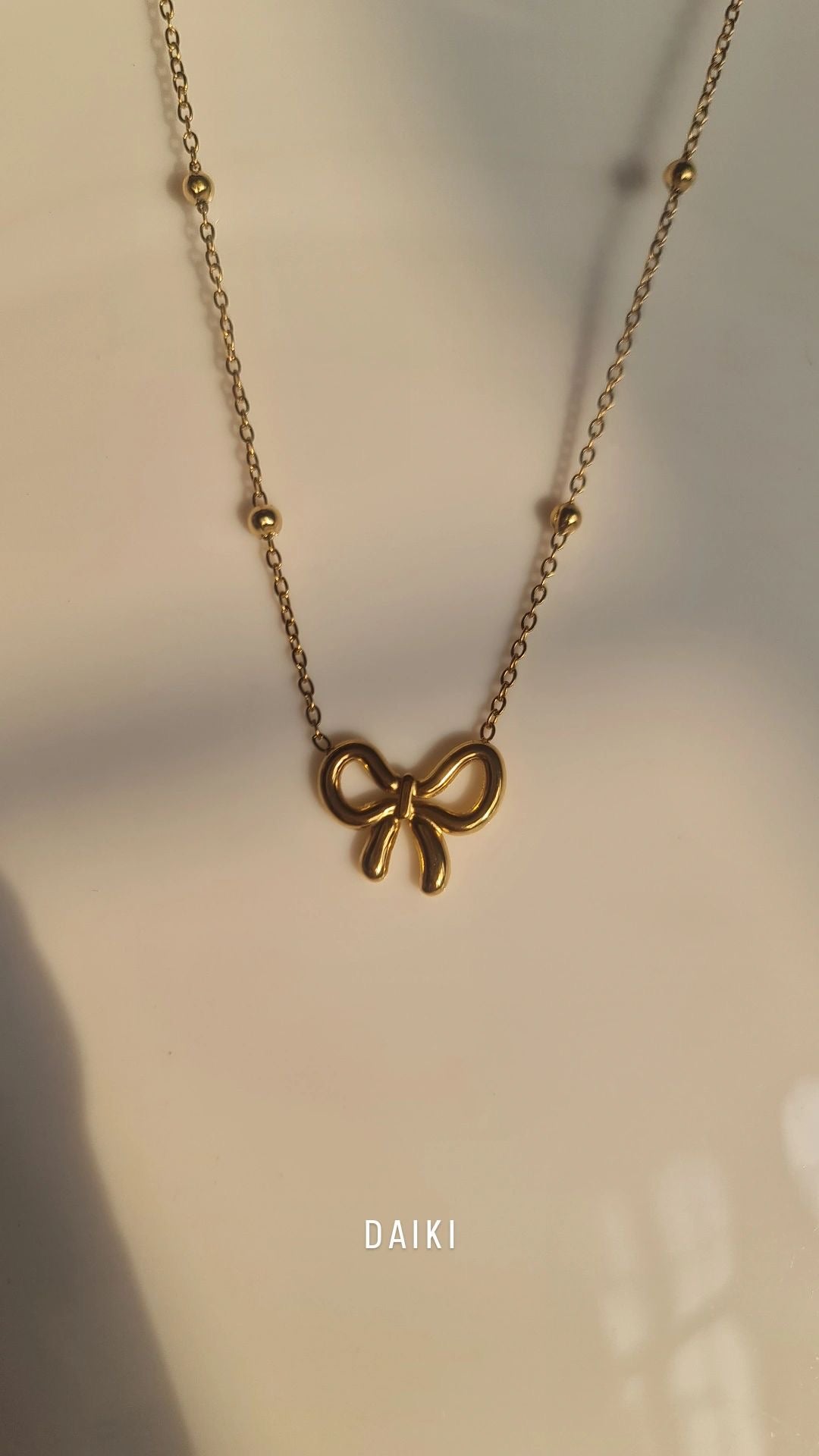 B117 BOW NECKLACE
